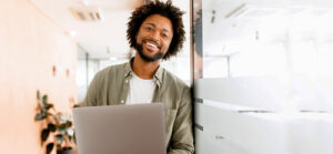 Person laughing on laptop in office
