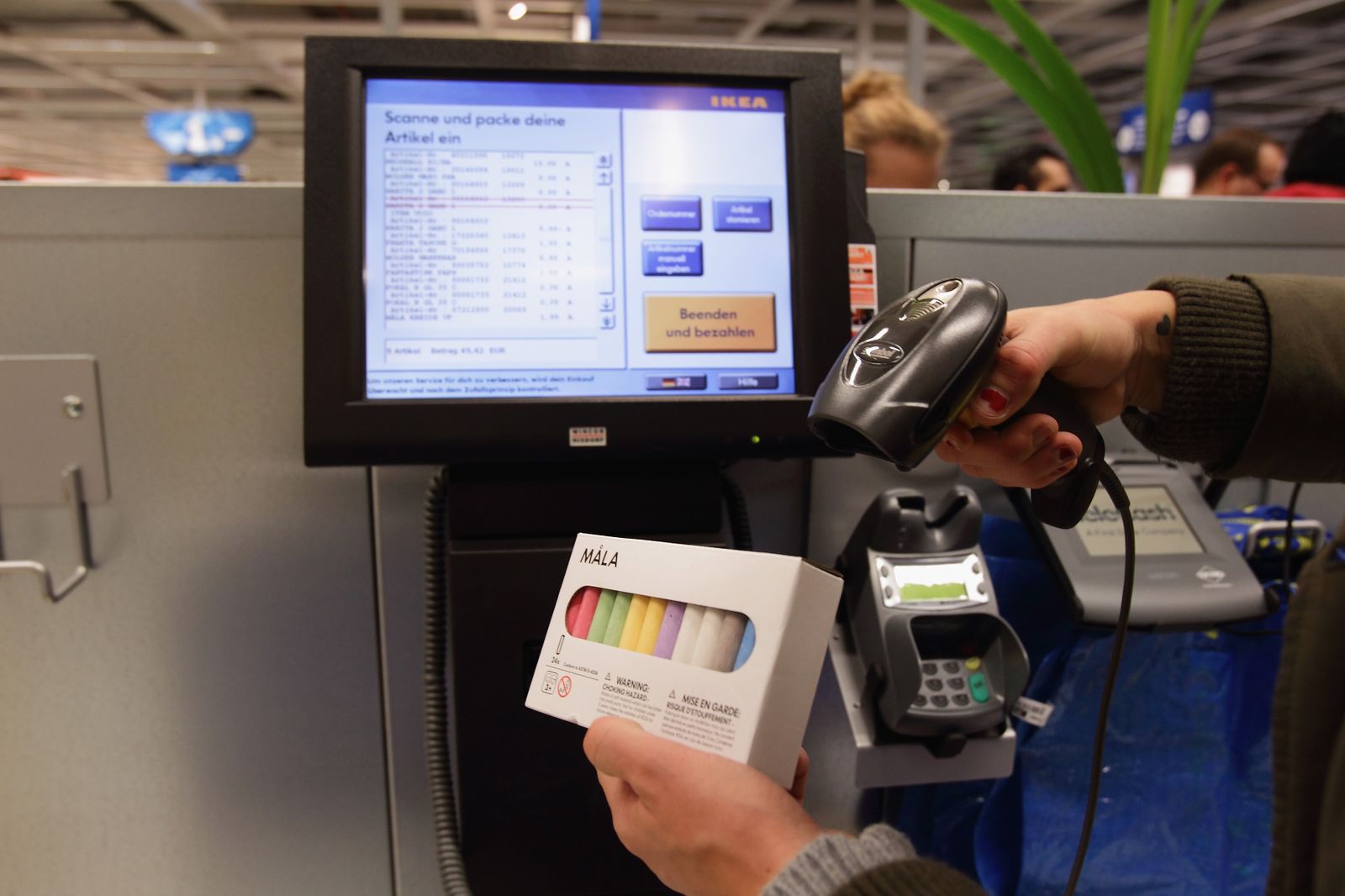 Someone using a self checkout machine in a store