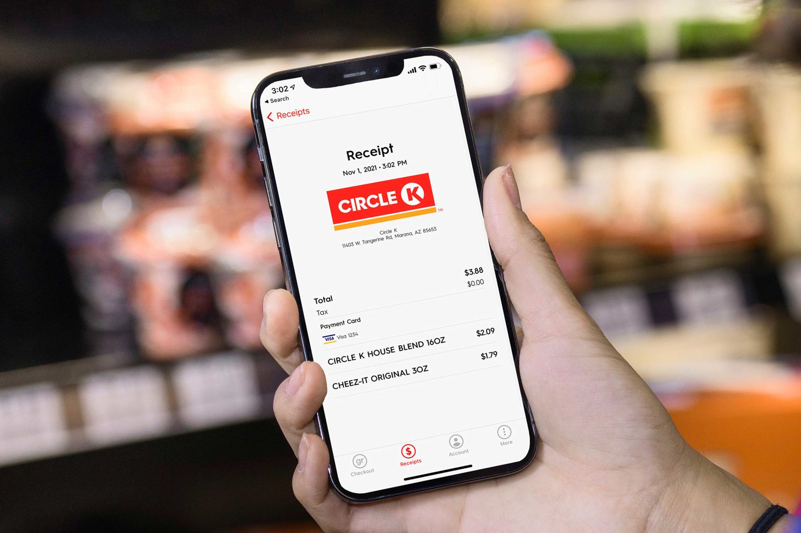 A hand holding a phone that's being used to buy items at Circle K via the Grabango technology.