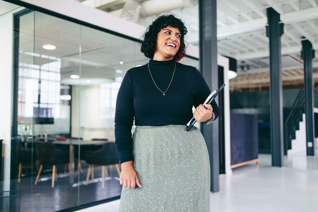 Marketer with a laptop smiling