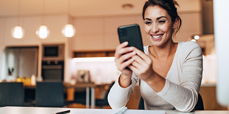 Person smiling while using phone