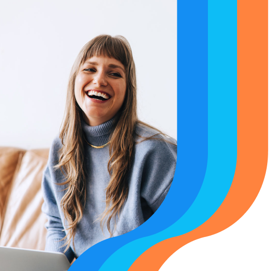 Person laughing using laptop
